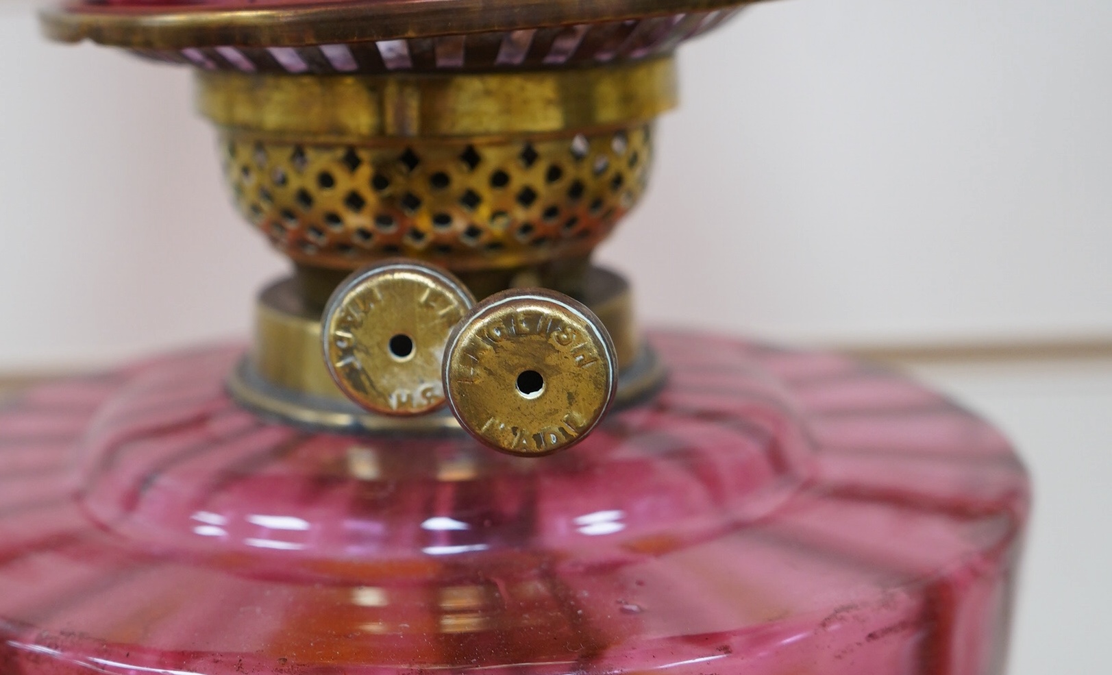 A Victorian oil lamp on brass base with cranberry font, acid etched cranberry shade chimney, overall 62cm high. Condition - good